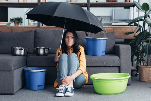 confused-girl-sitting-under-umbrella-in-living-roo-2024-11-18-06-36-34-utc (1).jpg